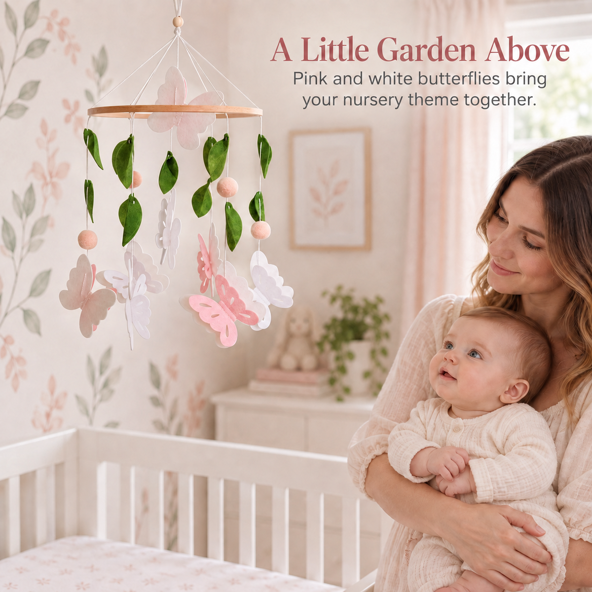 Pink and white butterfly baby mobile displayed in a garden inspired nursery