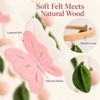 Close-up of layered felt butterfly and natural beech wood hoop