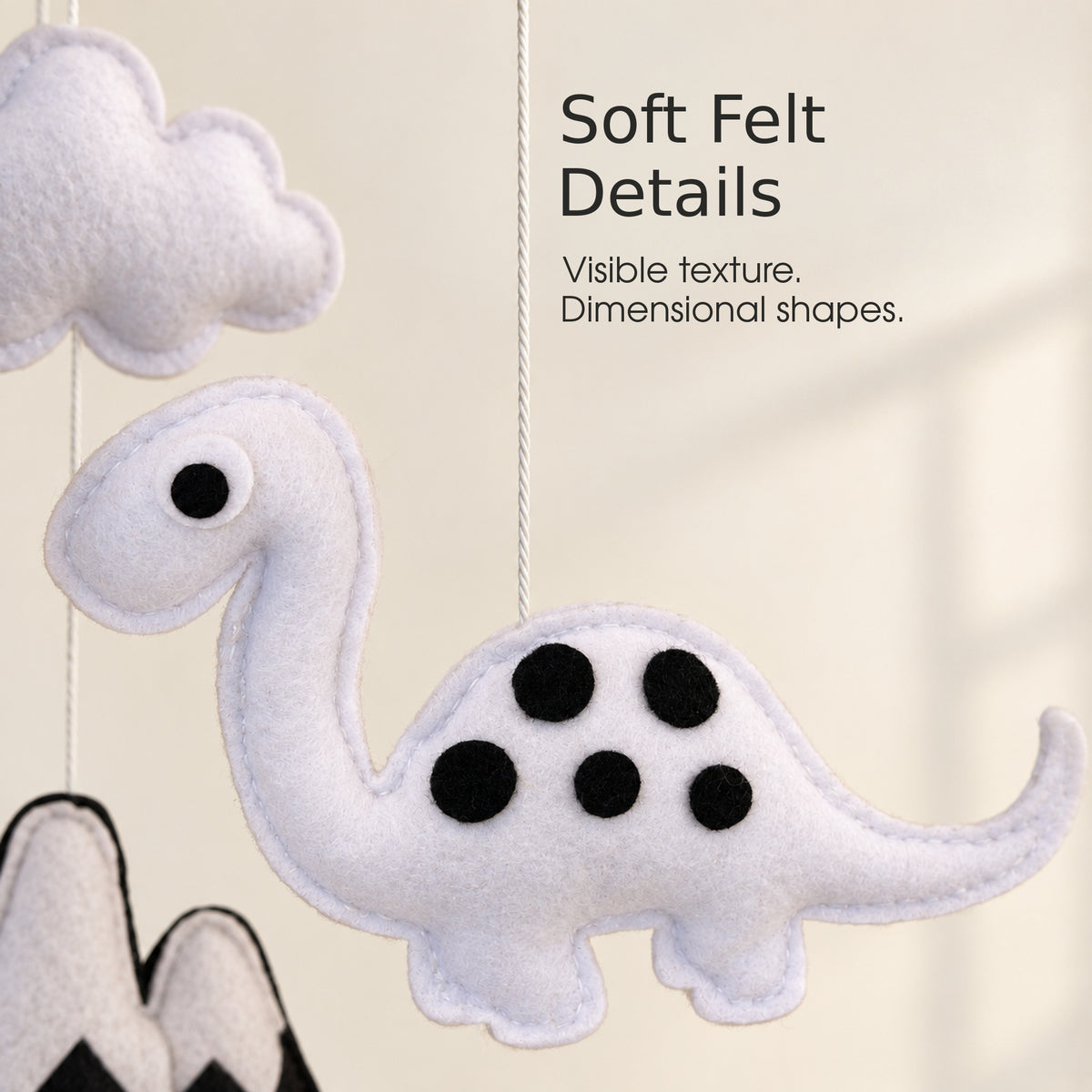 Close-up of felt dinosaur details on VLOKUP baby mobile
