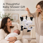 Dinosaur baby mobile shown in a baby shower nursery scene