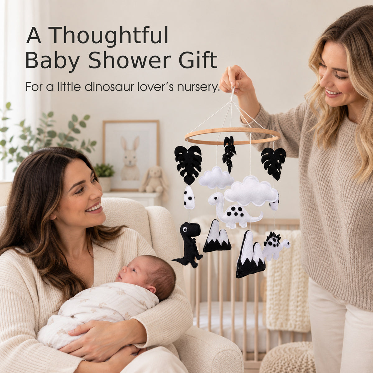 Dinosaur baby mobile shown in a baby shower nursery scene