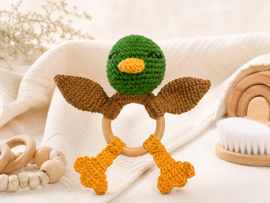 Crochet baby rattle with a wooden ring