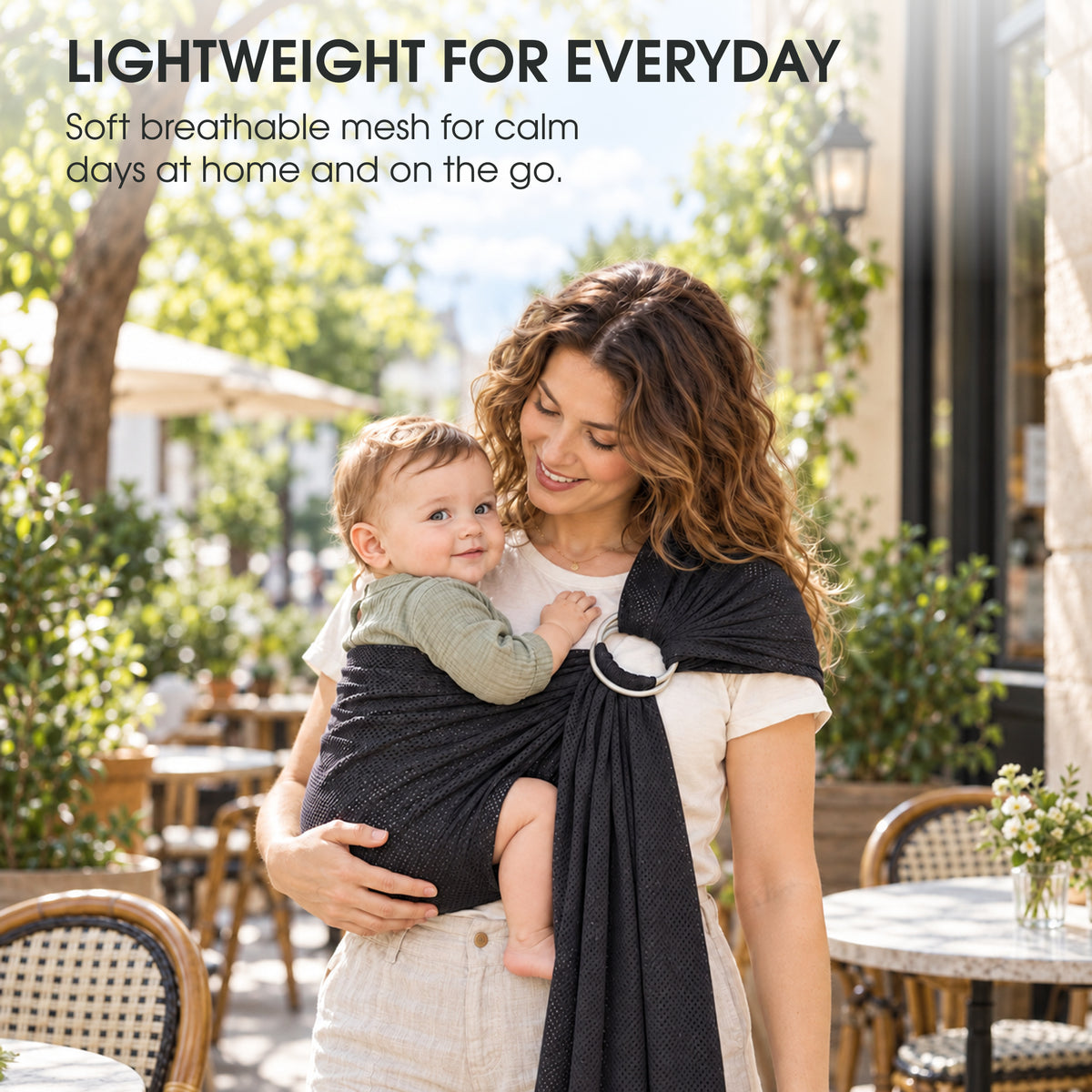A mother carrying her baby in a grey water ring sling outdoors, with text about lightweight everyday carrying
