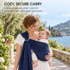 A mother carrying her baby in a navy ring sling outdoors, with text about a cozy, secure carry
